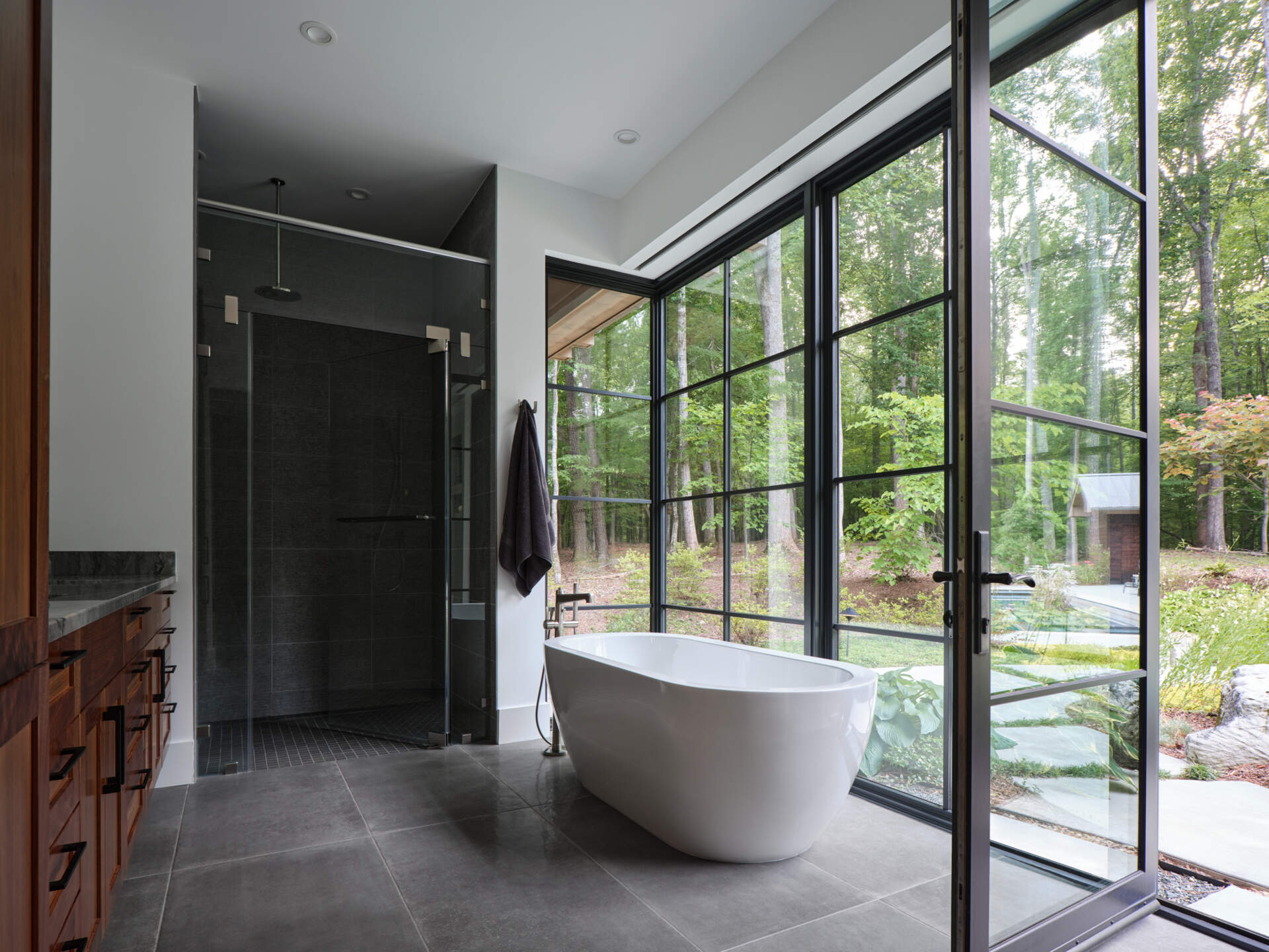 Soft light and natural materials create a calm, grounded bathroom connected to the primary suite.