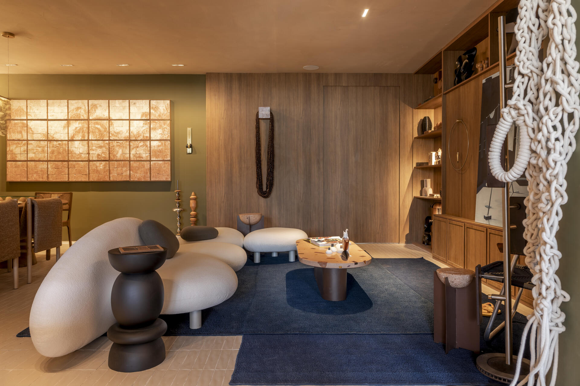 Green and blue tones define this living room, inspired by Rio’s forest and sea, with natural materials adding texture and warmth.