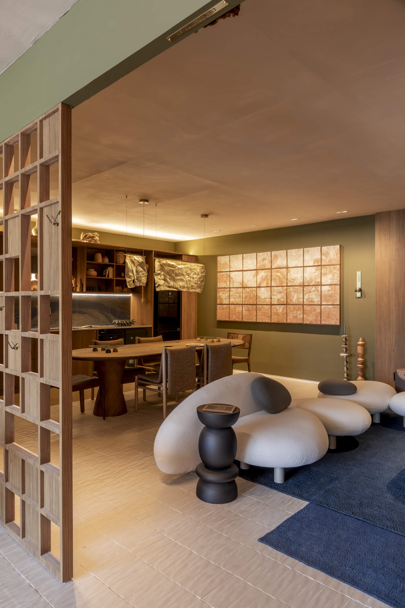 Green and blue tones define this living room, inspired by Rio’s forest and sea, with natural materials adding texture and warmth.