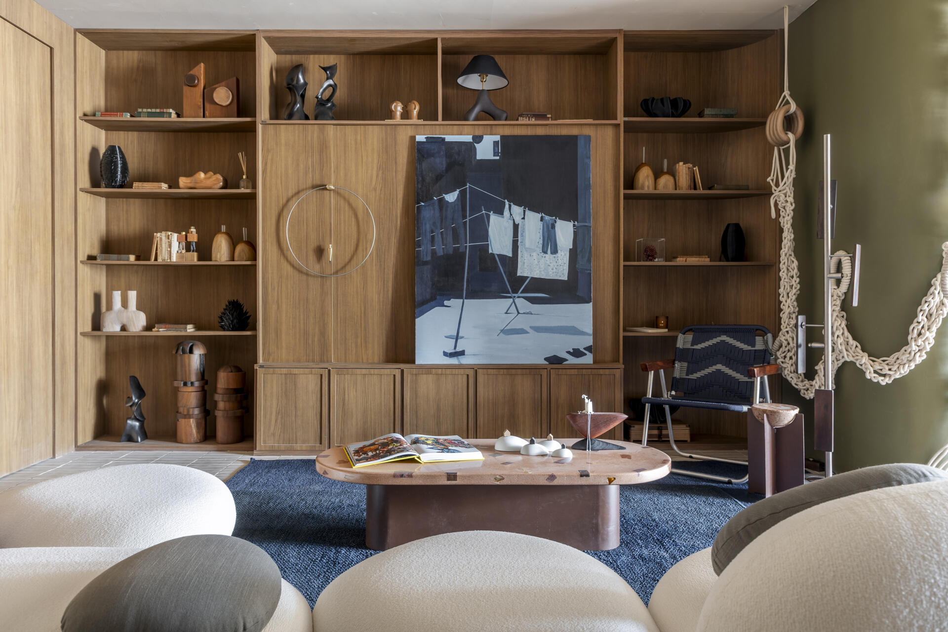 Green and blue tones define this living room, inspired by Rio’s forest and sea, with natural materials adding texture and warmth.