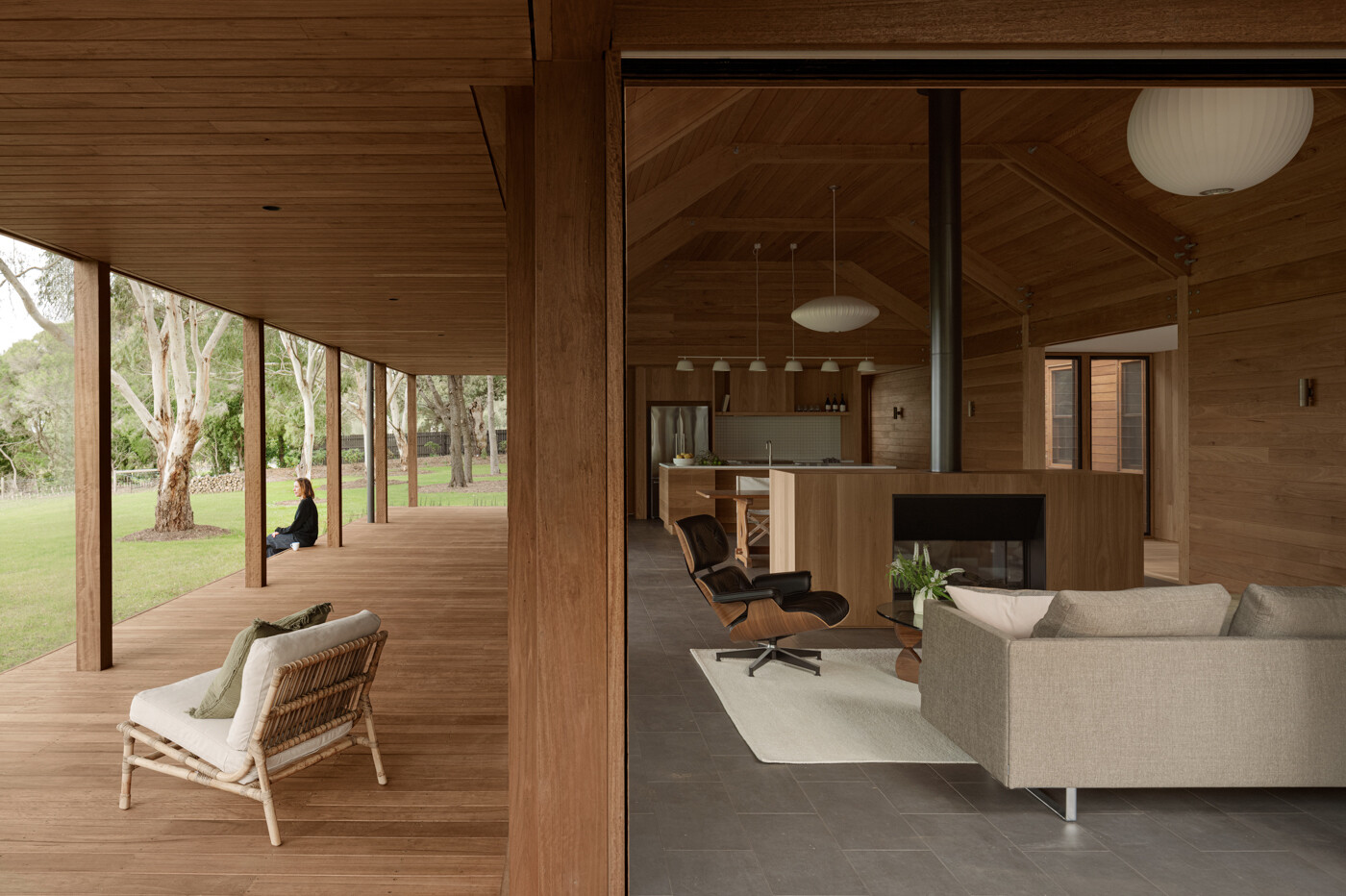 Verandas inspired by Australian vernacular architecture wrap the timber house, softening its scale and creating sheltered outdoor spaces that connect the home to its vineyard setting.
