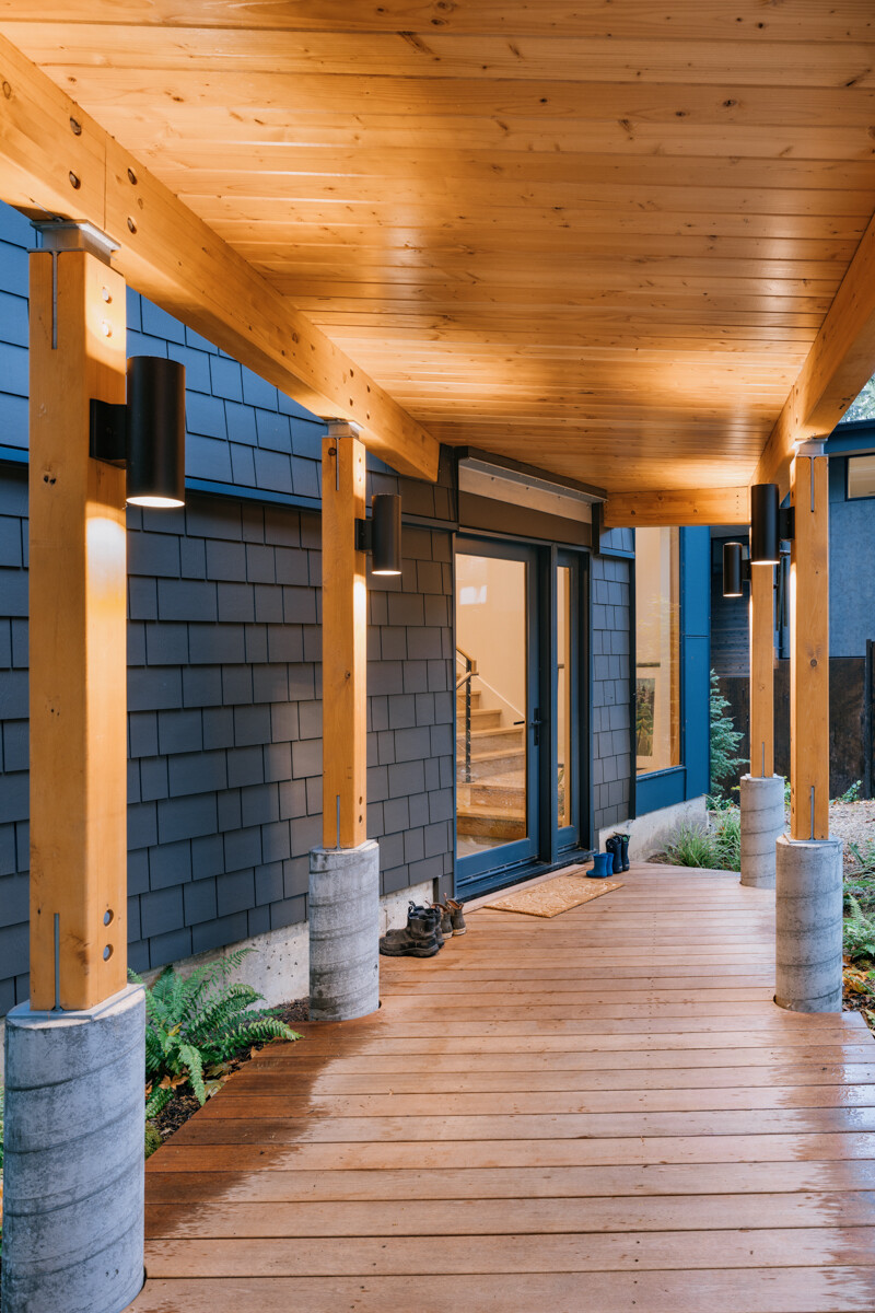 A covered pathway links the garage and office to the main house, acting as a front porch along the way. Topped with a green roof, it blends into the landscape while adding another usable layer to the design.