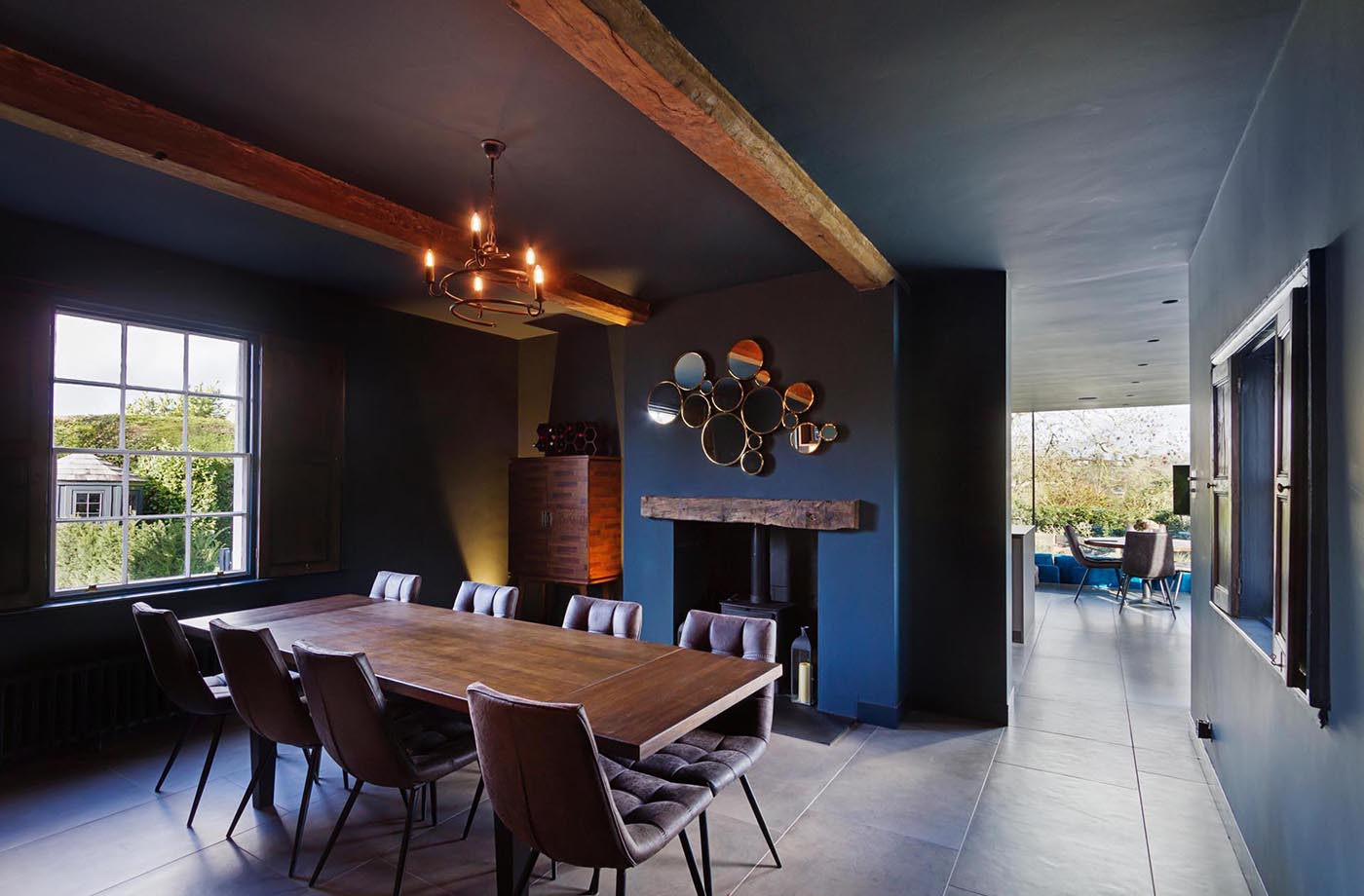 Exposed wood beams connect the modern extension back to the original cottage, blending old and new.