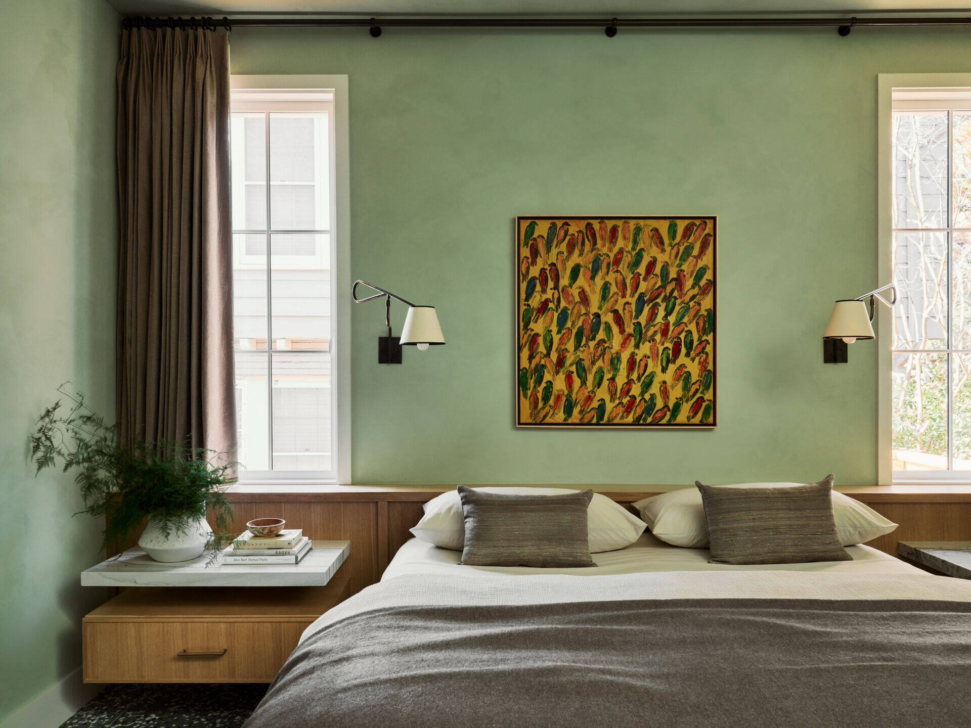 In the bedroom, deep greens and layered materials create a calm, immersive retreat away from the home’s brighter spaces.