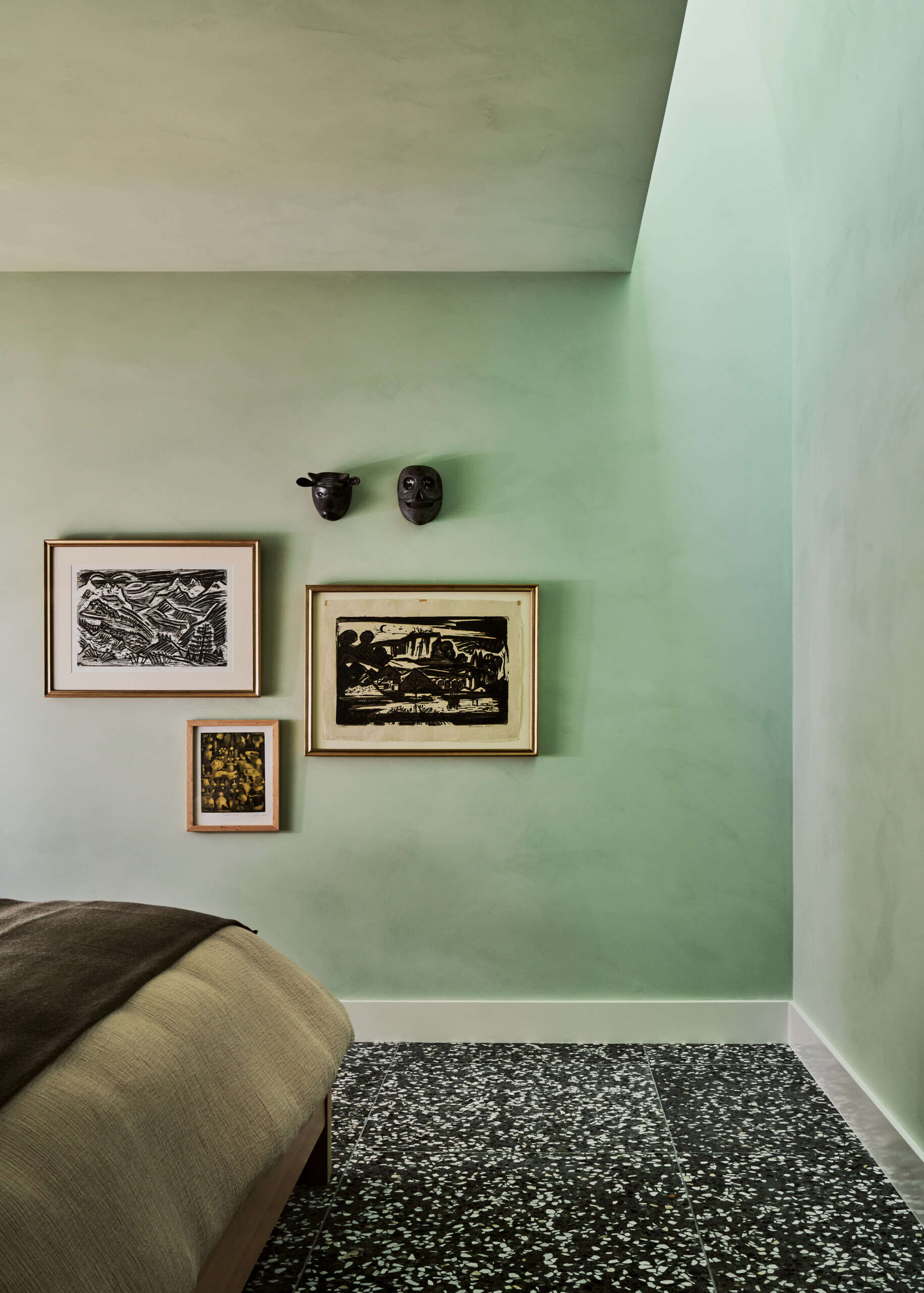 In the bedroom, deep greens and layered materials create a calm, immersive retreat away from the home’s brighter spaces.