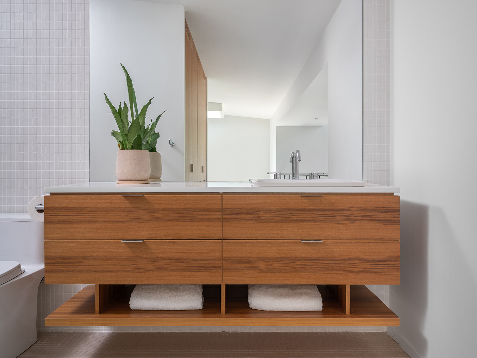 In the bedroom suite, a new layout introduces multiple bedrooms, a closet, and bathrooms, making better use of the upper level.