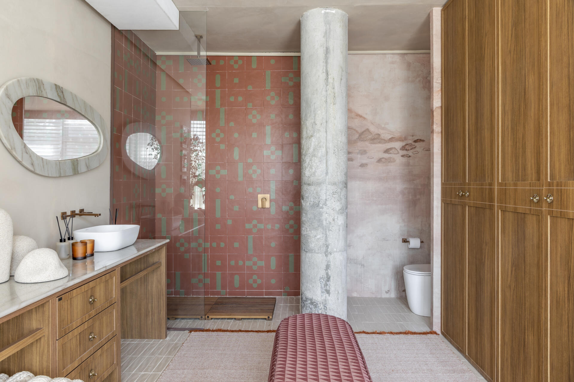 A warm, refined bathroom that continues the softer palette of the private areas for a cohesive feel.