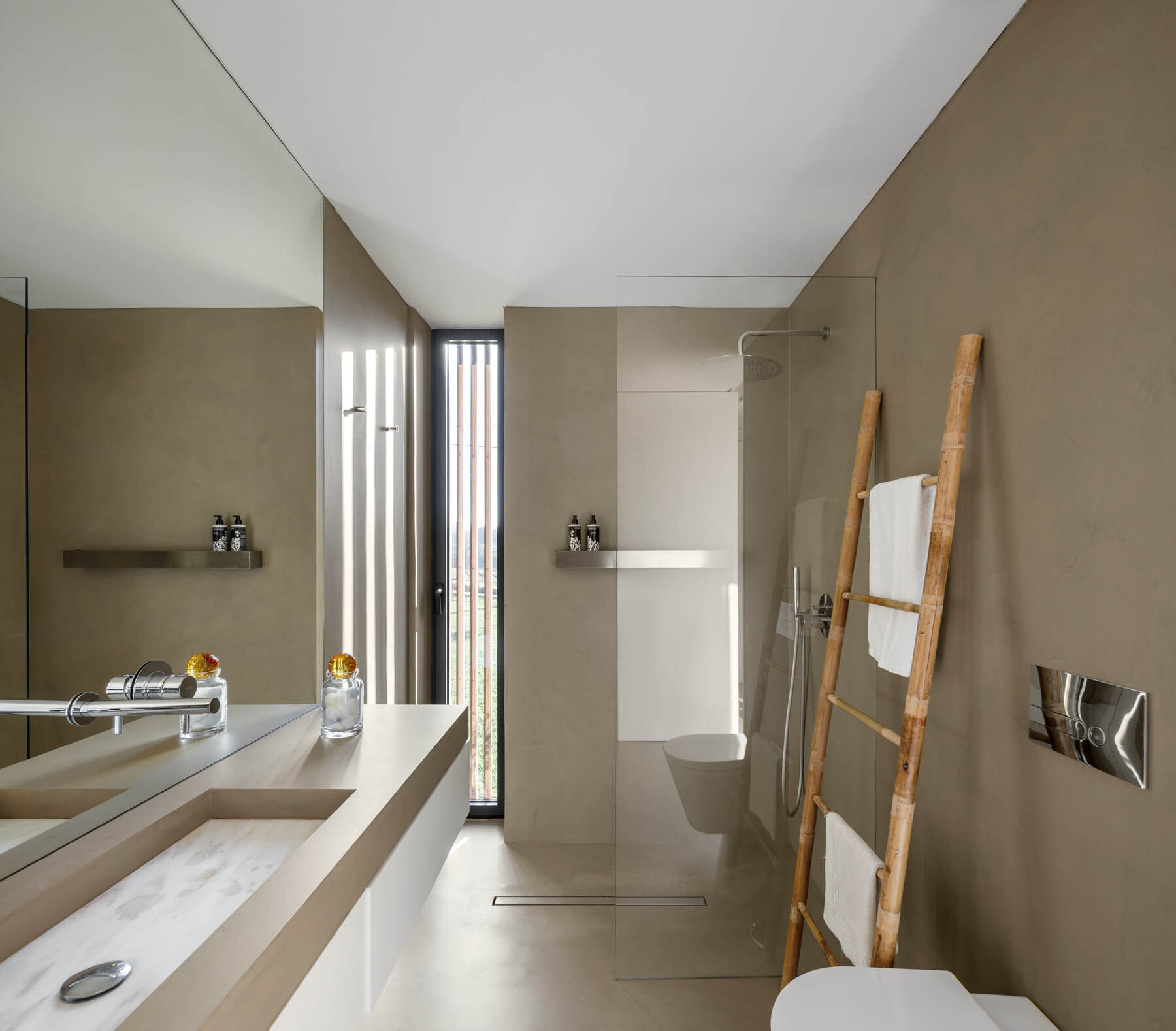 Large mirrors and built-in sinks create bright, uncluttered bathrooms that feel more spacious and refined.