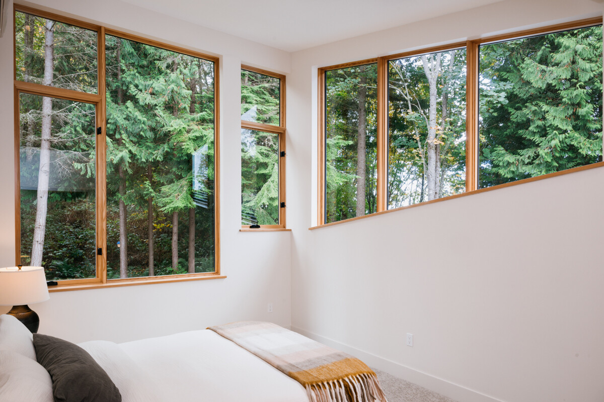 A serene bedroom set among the treetops, offering a peaceful, elevated perspective of the landscape.