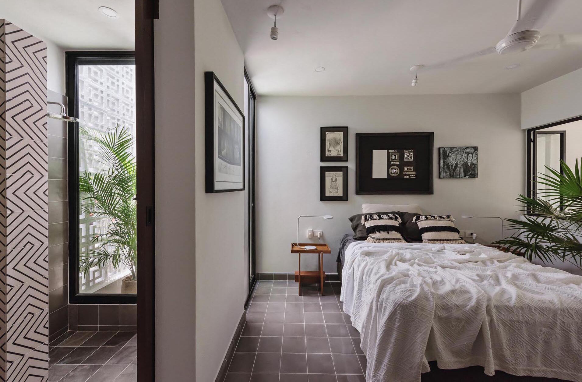 A mezzanine bedroom overlooks the double height living space and opens to a tiny planted garden, creating a calm and light filled retreat.