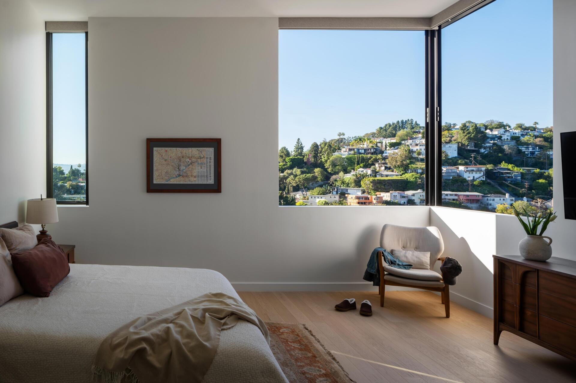 The bedrooms are arranged to feel more private, while still taking advantage of views where possible. Openings are placed carefully, balancing outlook with a sense of enclosure.