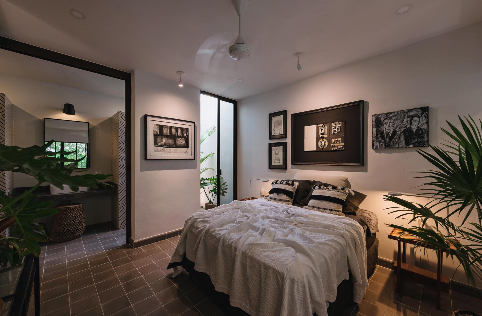 A mezzanine bedroom overlooks the double height living space and opens to a tiny planted garden, creating a calm and light filled retreat.