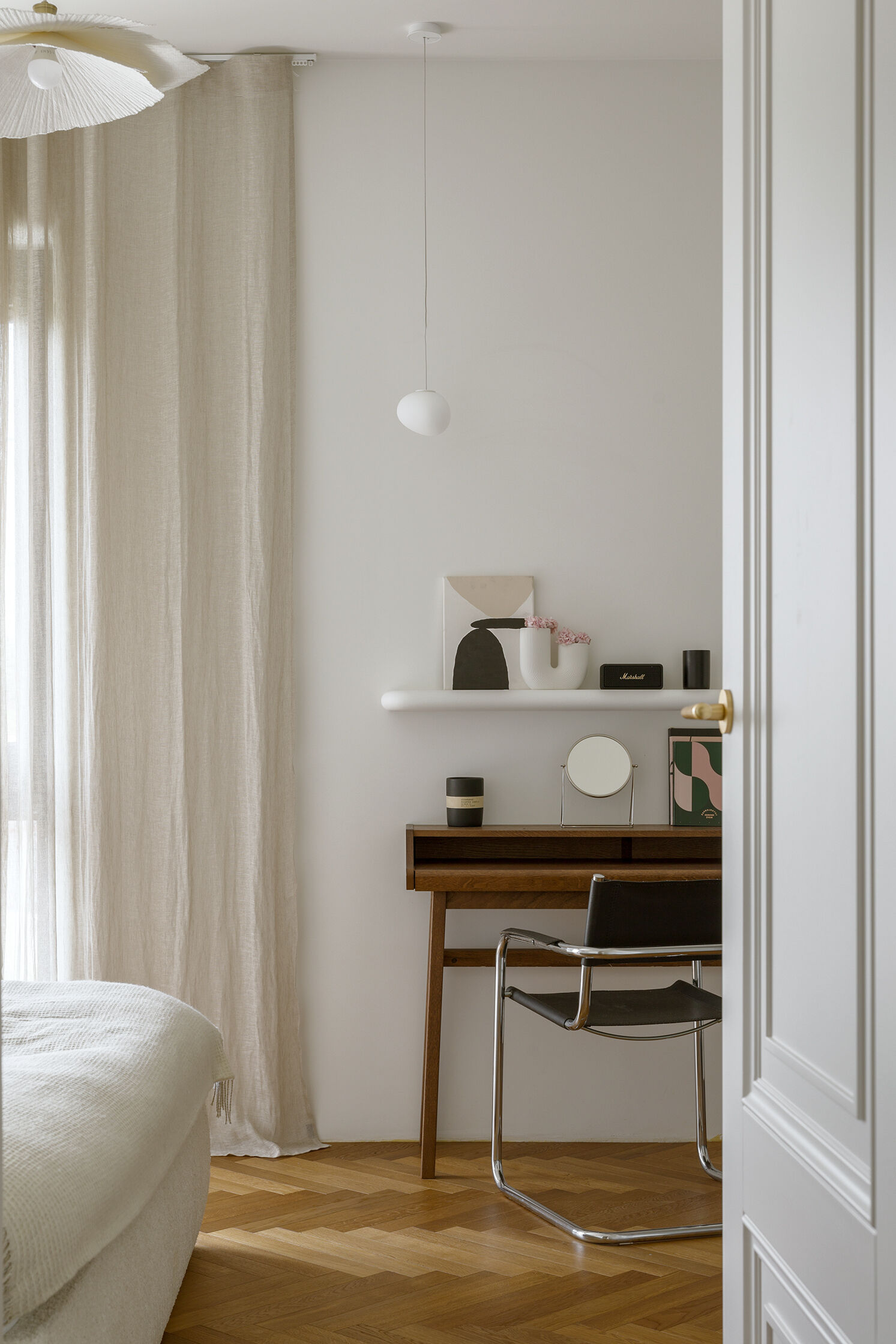A serene bedroom with soft tones and gentle forms designed to create a calm, grounded atmosphere.