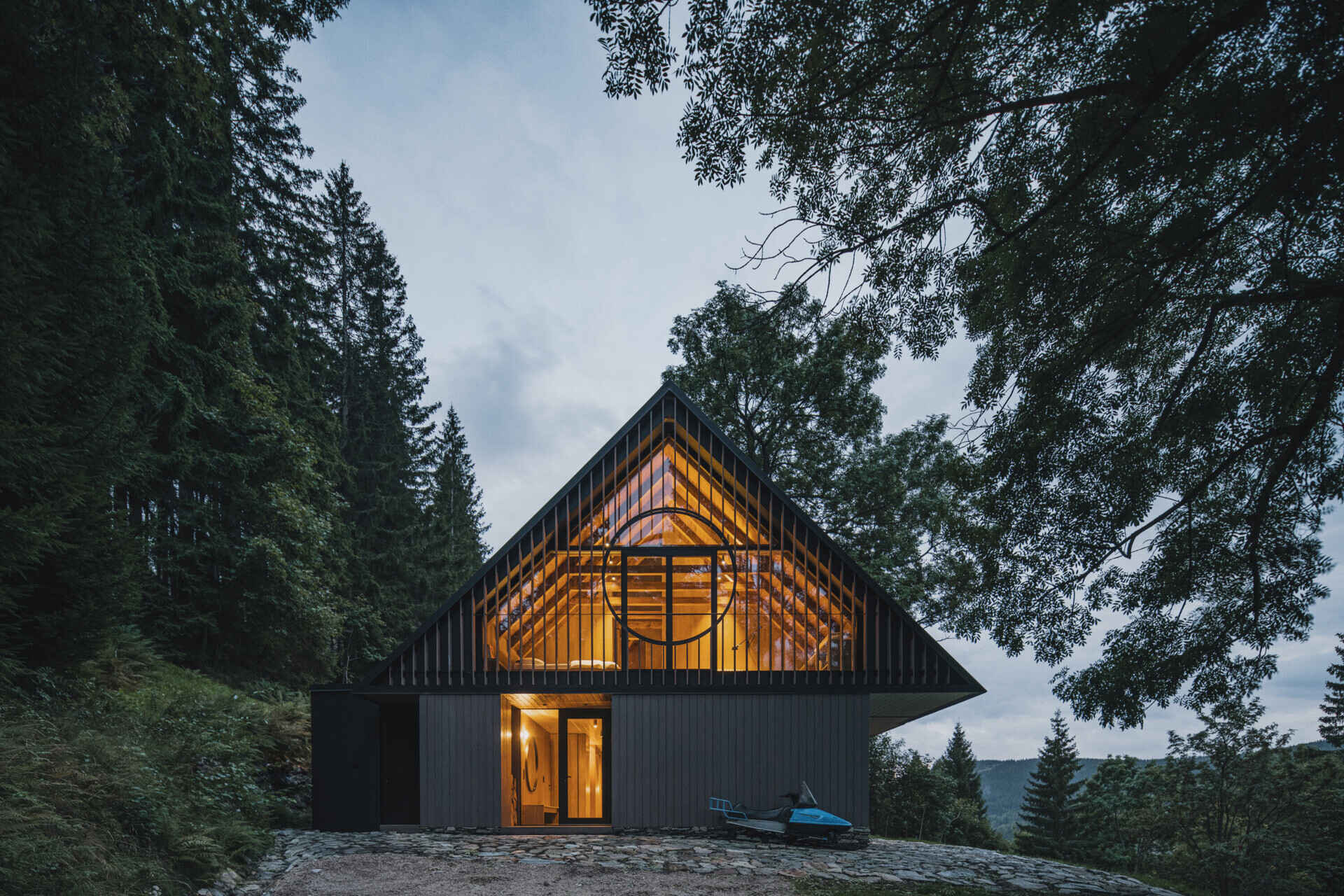Traditional mountain cottage with steep roofs, stone bases, and timber gables blending authentic design with modern simplicity.