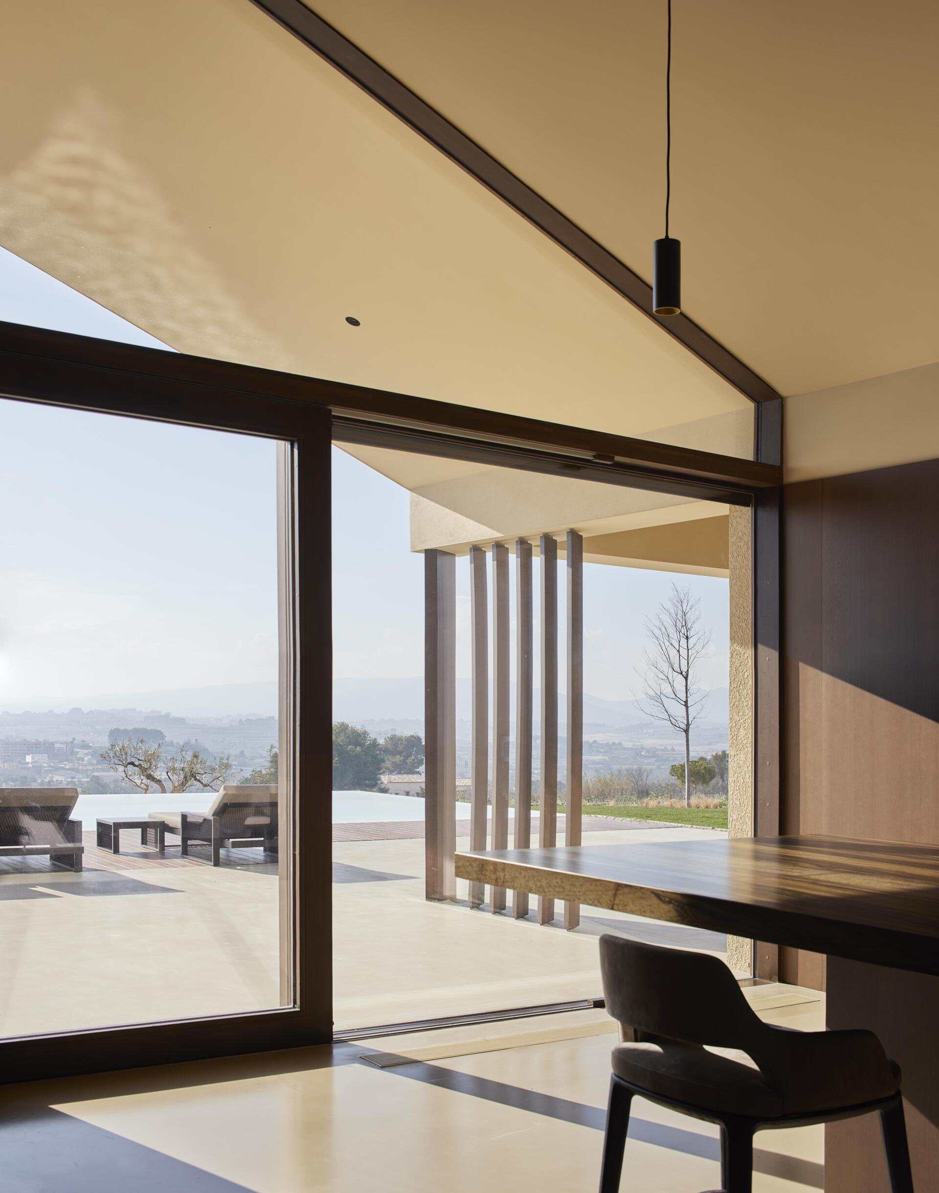 This modern kitchen connects directly to outdoor cooking and dining areas, designed for both everyday use and entertaining.
