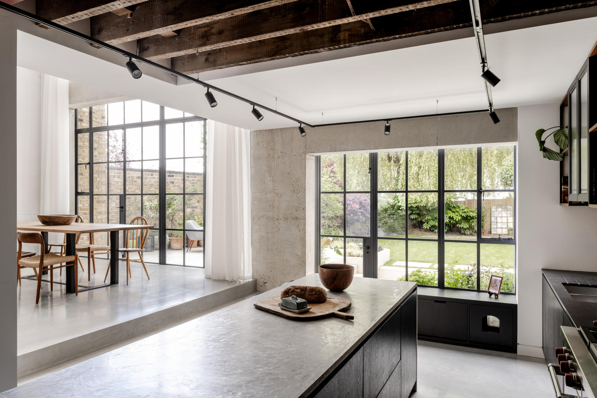 The kitchen features a distinctive tiled splashback inspired by the decorative columns of Harrods’ historic Food Hall, adding a playful reference to London’s architectural heritage.