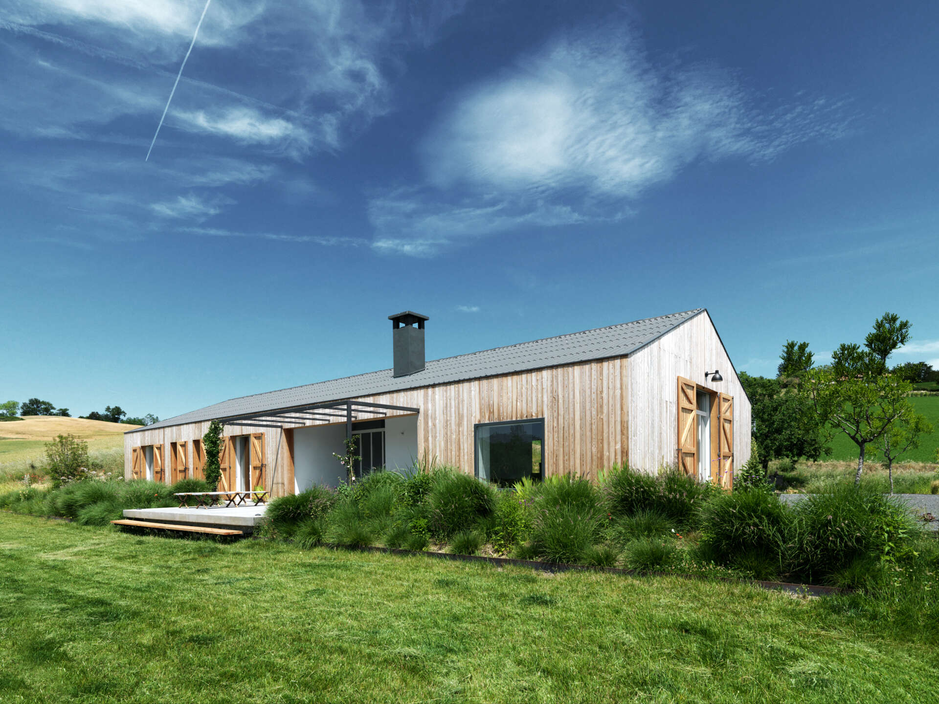 The farmhouse’s larch wood siding ages to a soft gray, offering natural insulation and blending seamlessly into the Italian countryside.