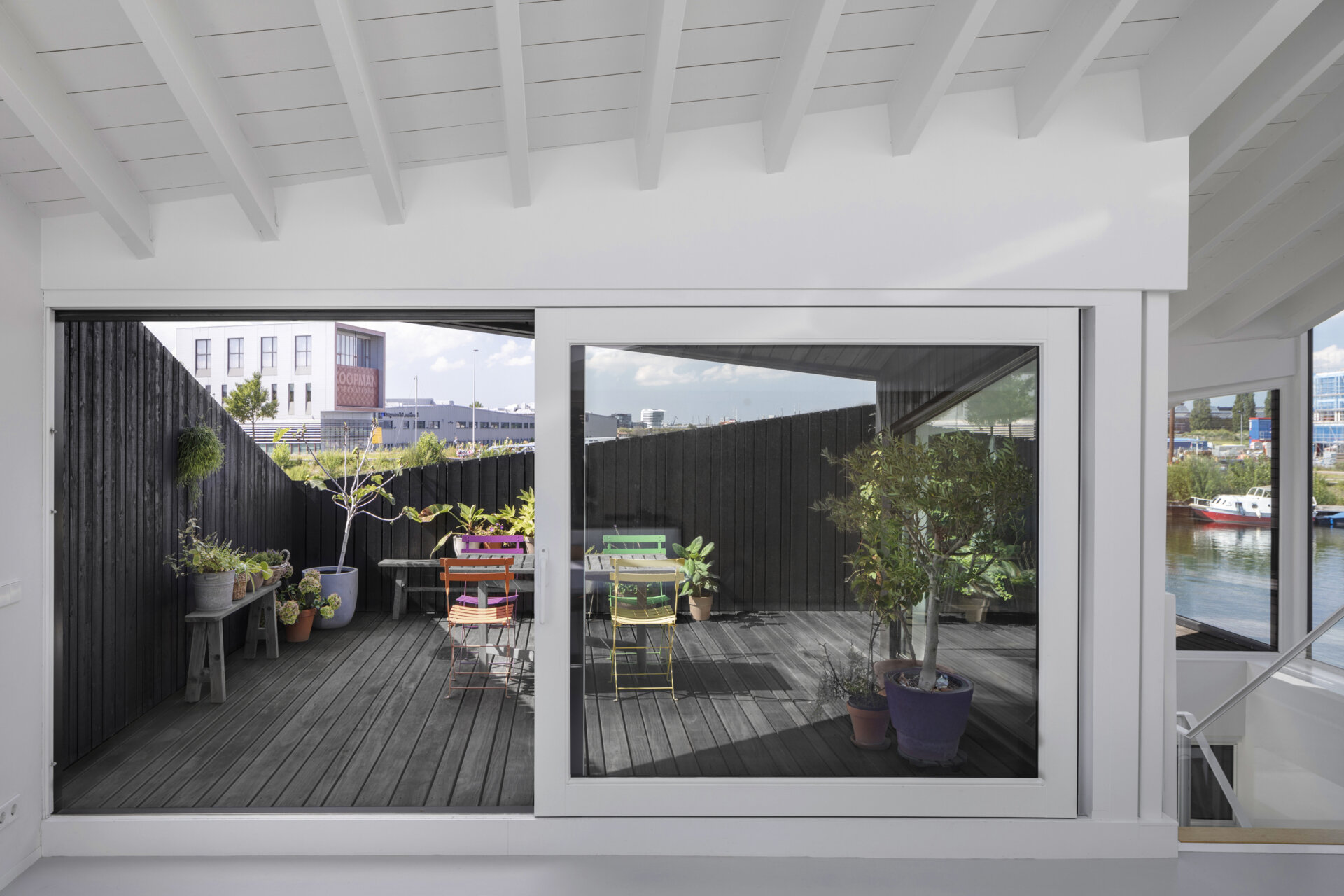 Angled walls create privacy on the rooftop deck while keeping the space open to the sky and water.