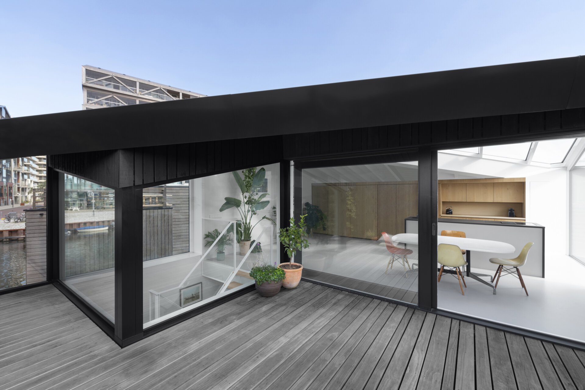 Angled walls create privacy on the rooftop deck while keeping the space open to the sky and water.