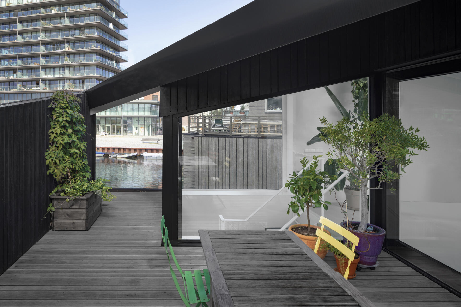 Angled walls create privacy on the rooftop deck while keeping the space open to the sky and water.
