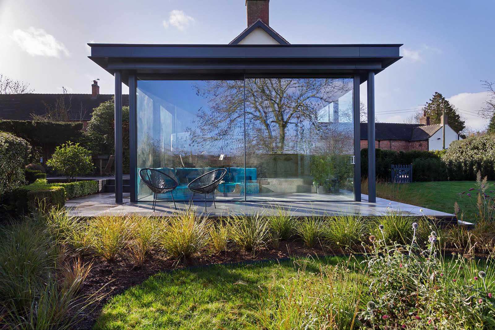 A spacious patio extends the living area outdoors, creating the perfect setup for dining and relaxing in the garden.