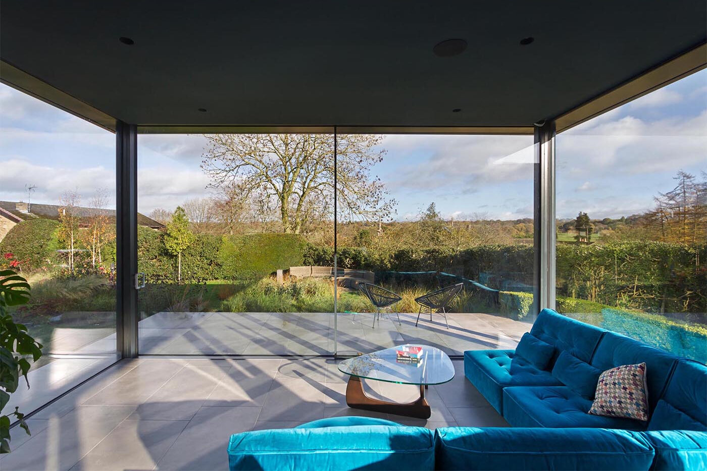 A 1960s-inspired split-level layout creates a relaxed living zone with uninterrupted garden views.