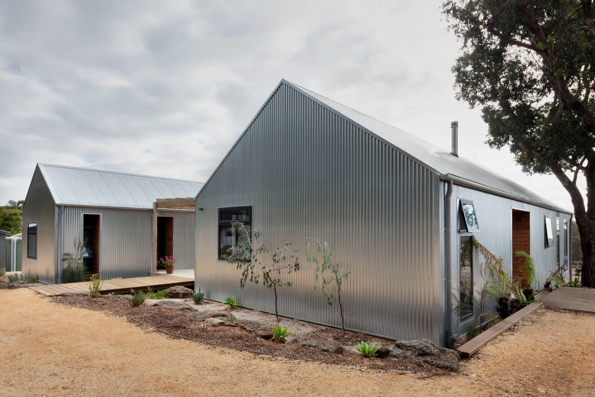 A modern rural home in Bellbrae designed as two separate pavilions connected by a central deck, created for flexible living and family visits.