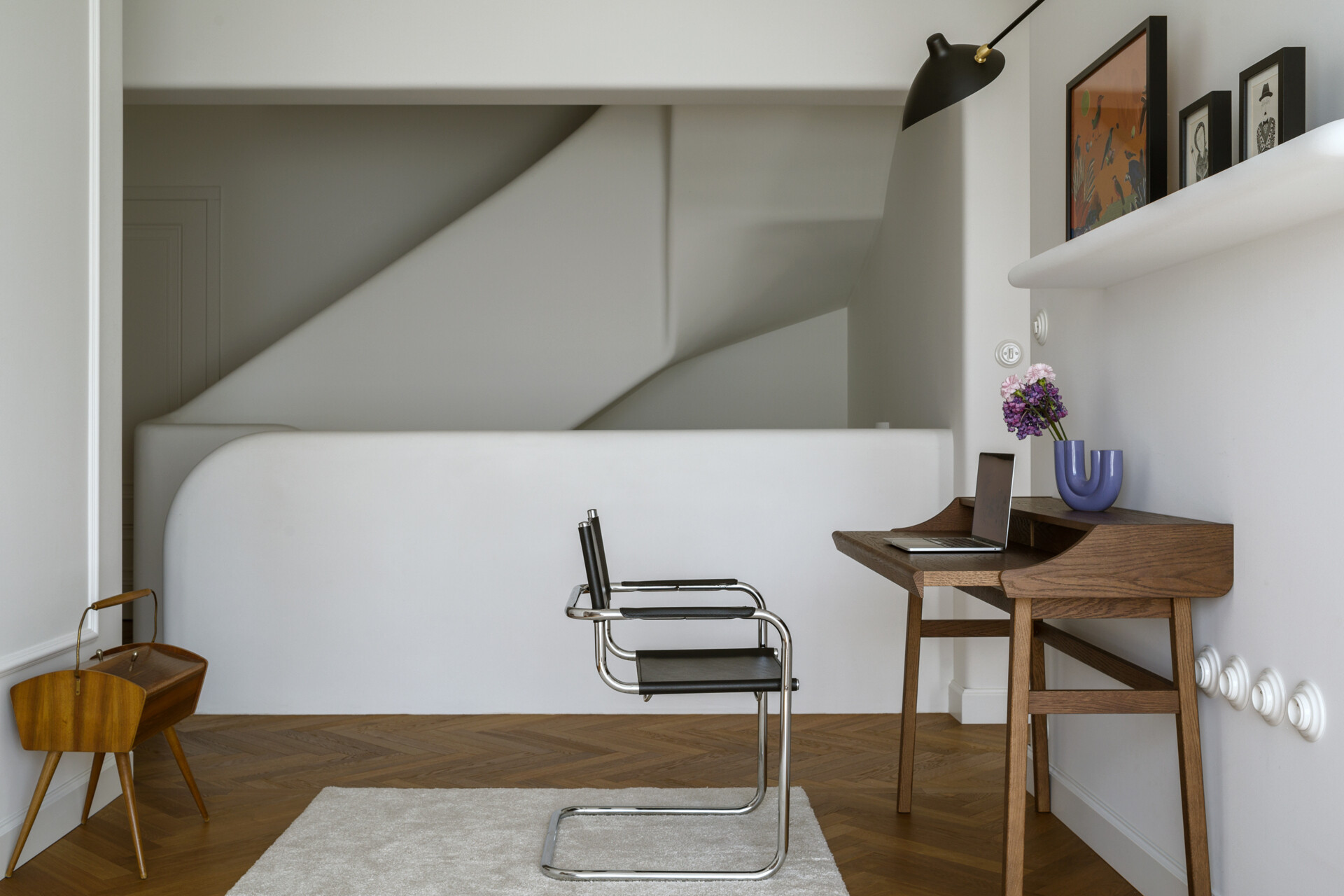 A light-filled home office that stays connected to the living space through open design and a consistent material palette.