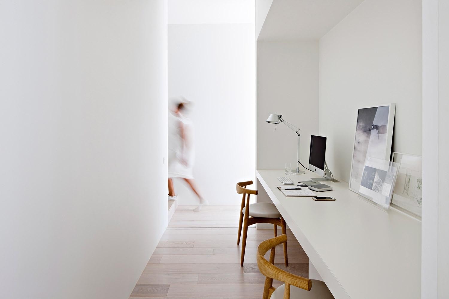 Tucked behind the fireplace and hidden from view, this double home office balances openness with privacy in a modern family home.