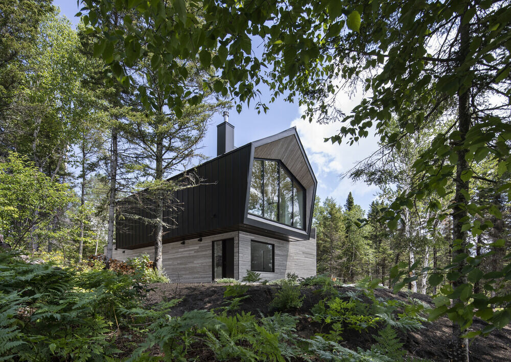 This Quebec home in Charlevoix blends minimalist design with breathtaking St. Lawrence River views for a serene retreat.
