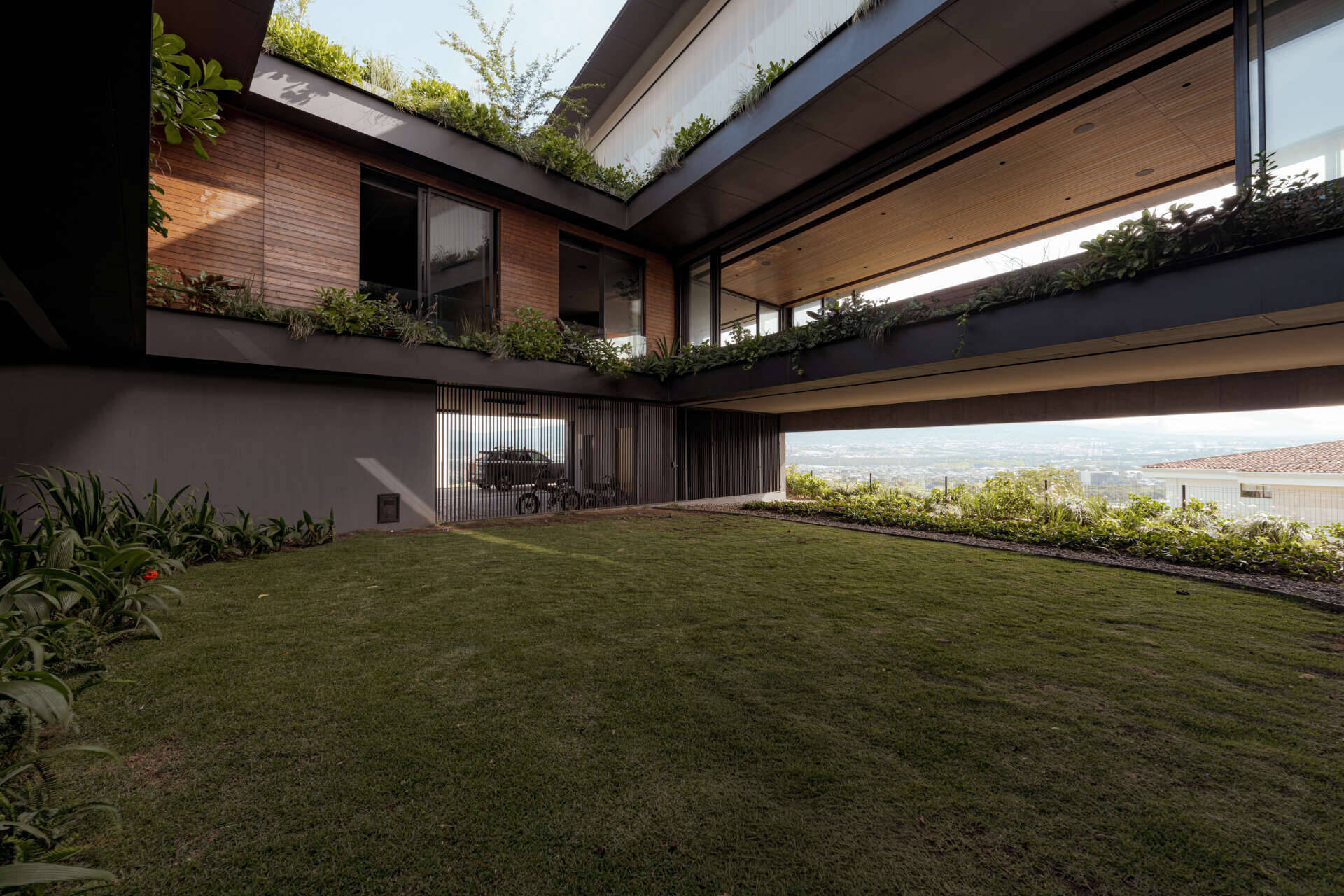 A central courtyard filled with greenery that brings light, air, and a sense of openness into every level of the home.
