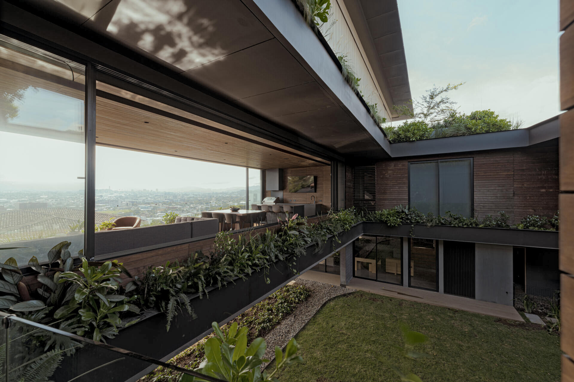 A central courtyard filled with greenery that brings light, air, and a sense of openness into every level of the home.