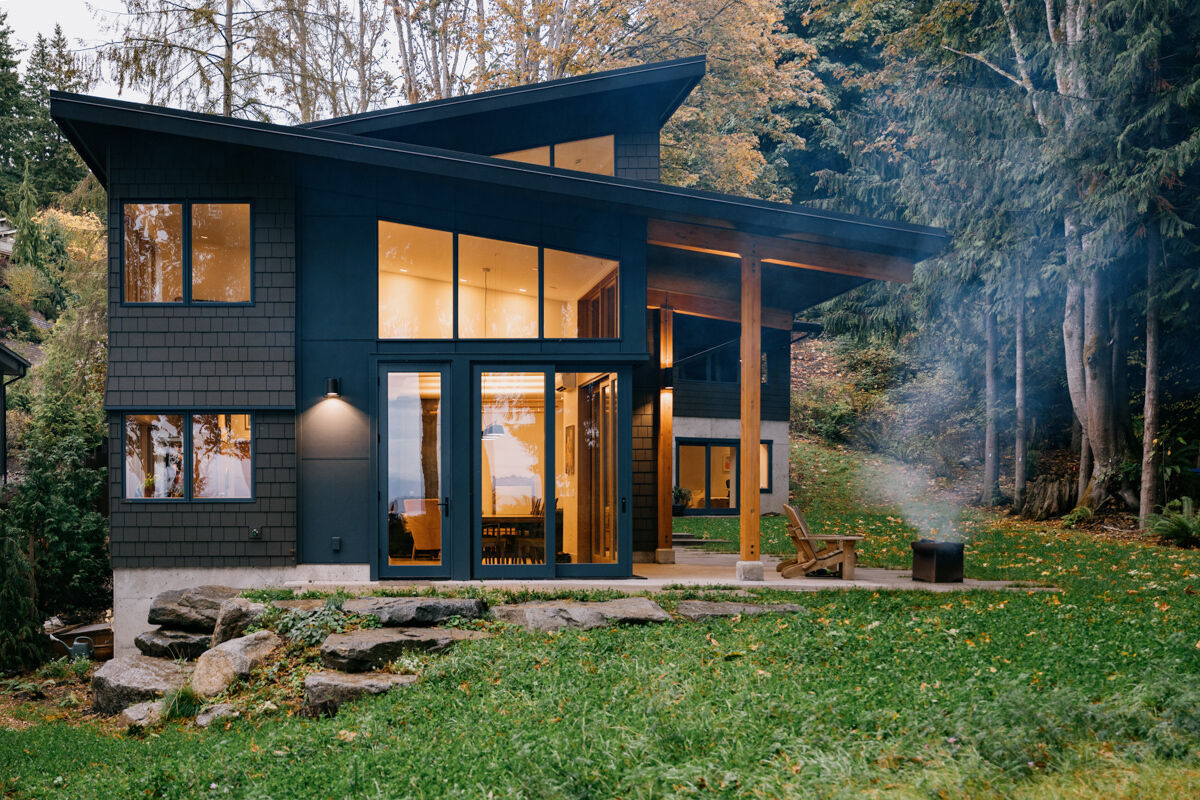 A modern Pacific Northwest home is divided into two wings that frame a natural meadow, making the landscape the heart of the design.