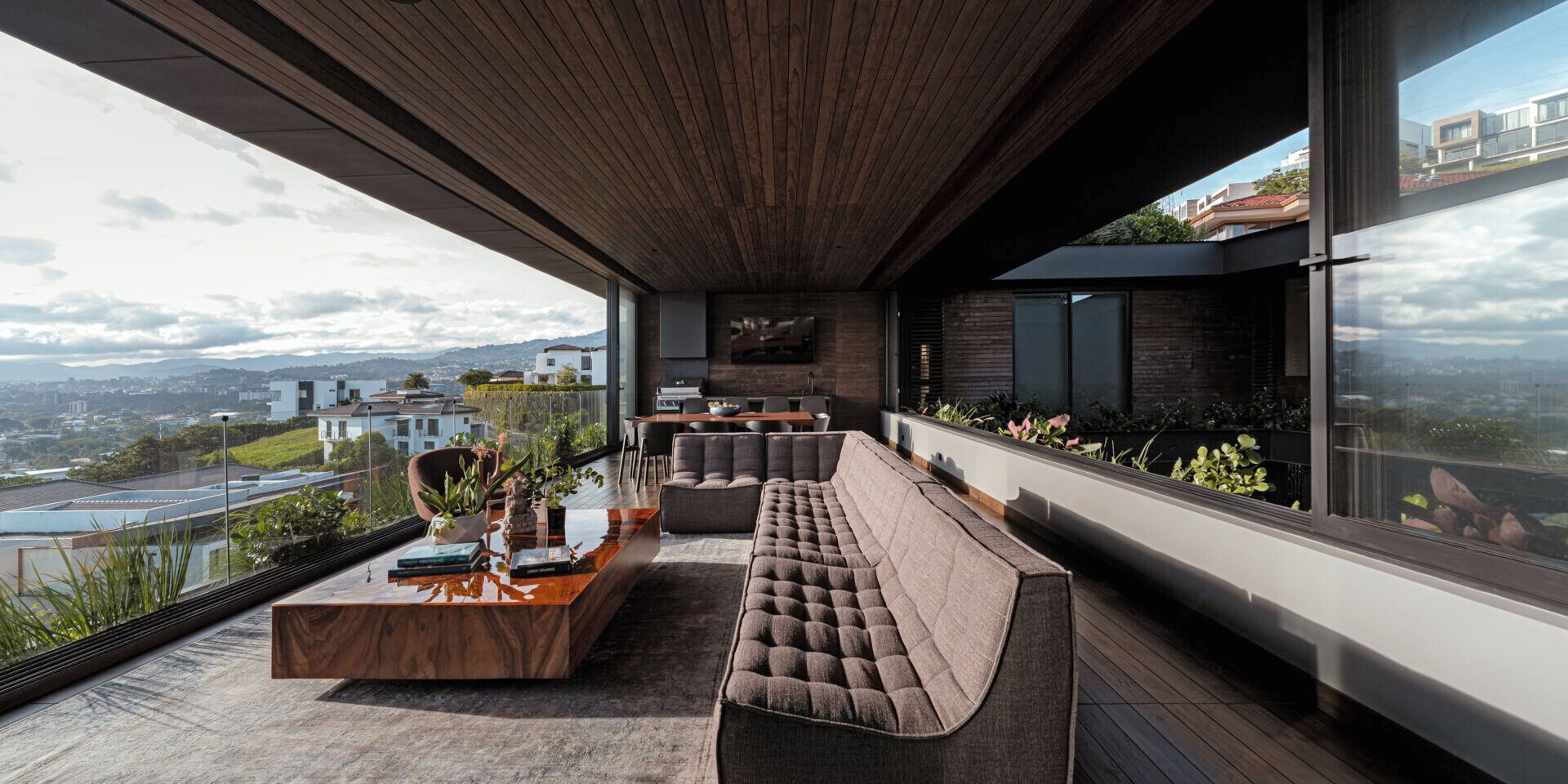 Open, light-filled interiors centered around a courtyard, with natural materials, filtered sunlight, and seamless flow between living spaces.