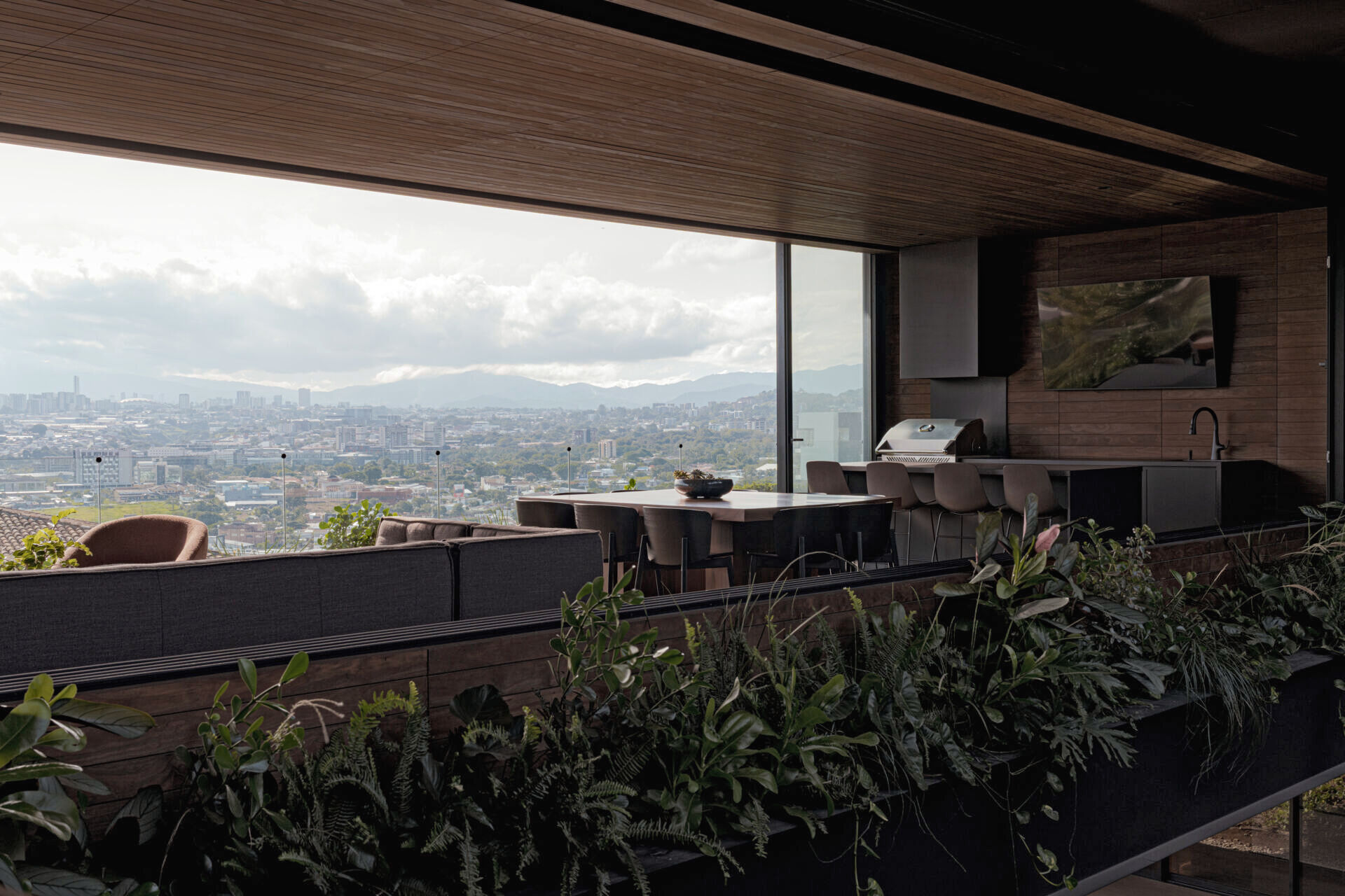 Open, light-filled interiors centered around a courtyard, with natural materials, filtered sunlight, and seamless flow between living spaces.