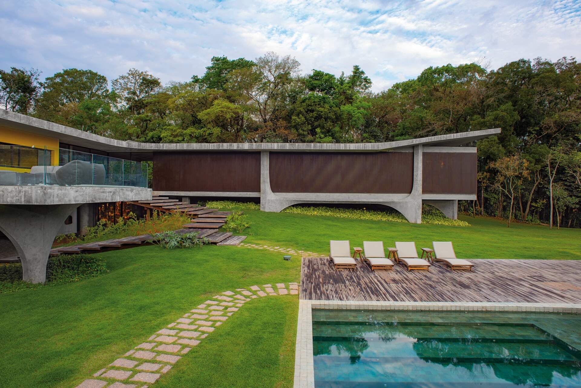 A swimming pool framed by a large wood deck, creating a clean and inviting outdoor space for relaxing and entertaining.
