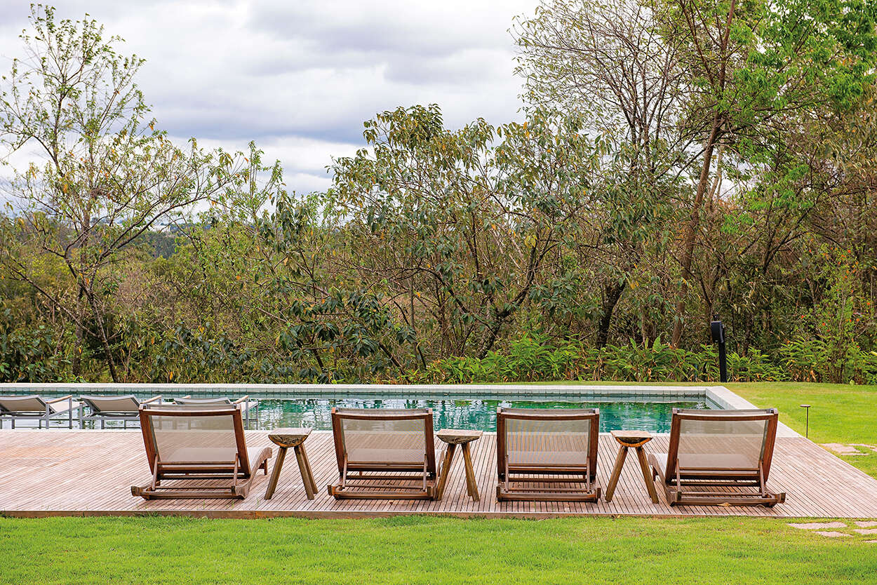 A swimming pool framed by a large wood deck, creating a clean and inviting outdoor space for relaxing and entertaining.