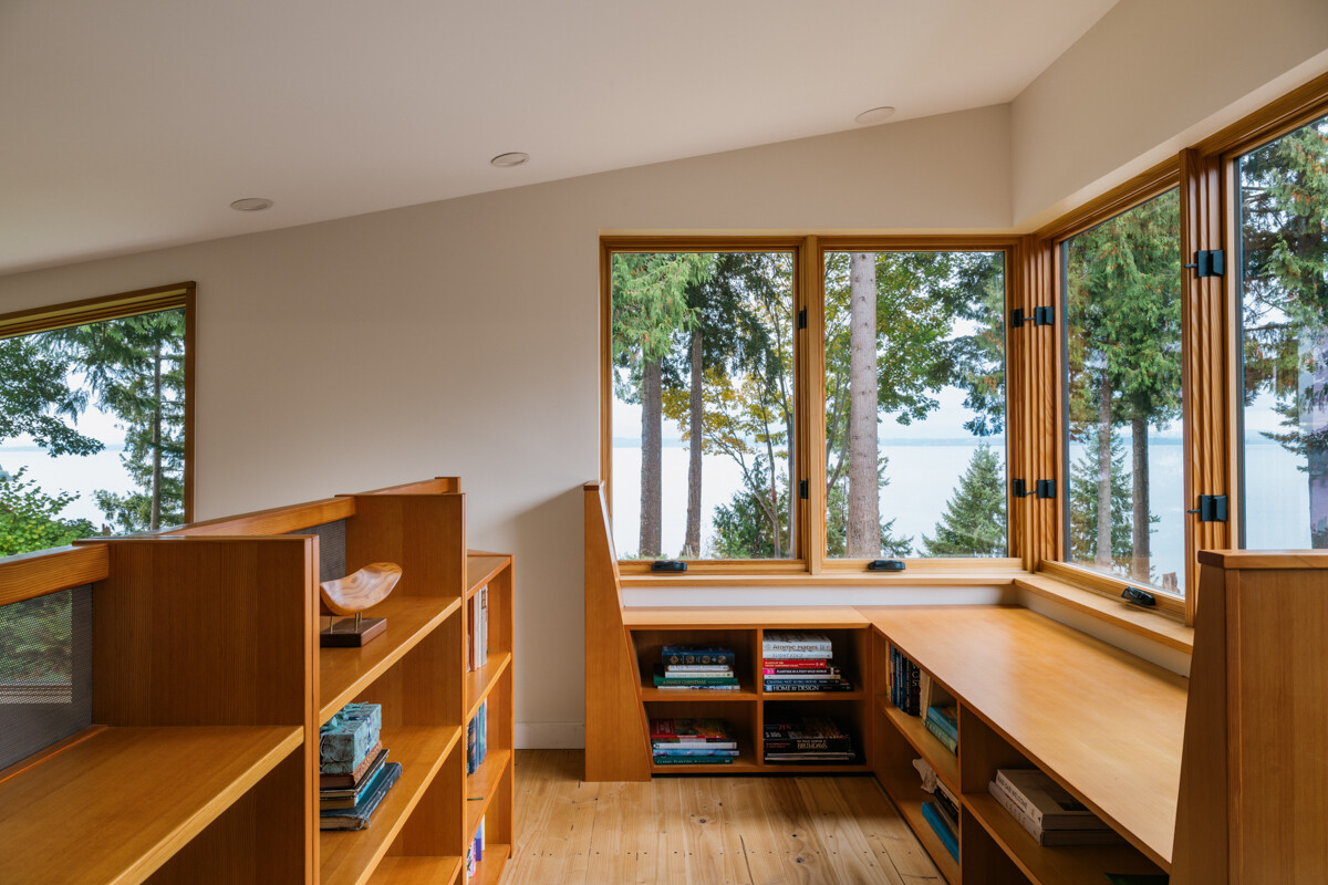 A cozy library loft with custom-built furniture, adding a personal and crafted feel to the home.