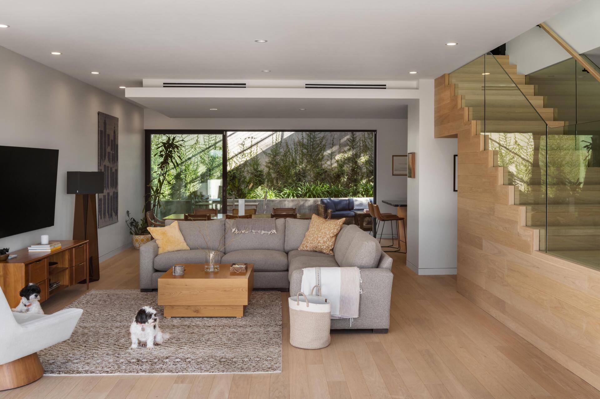 The dining and kitchen areas are located behind the living room with each space leading naturally into the next.