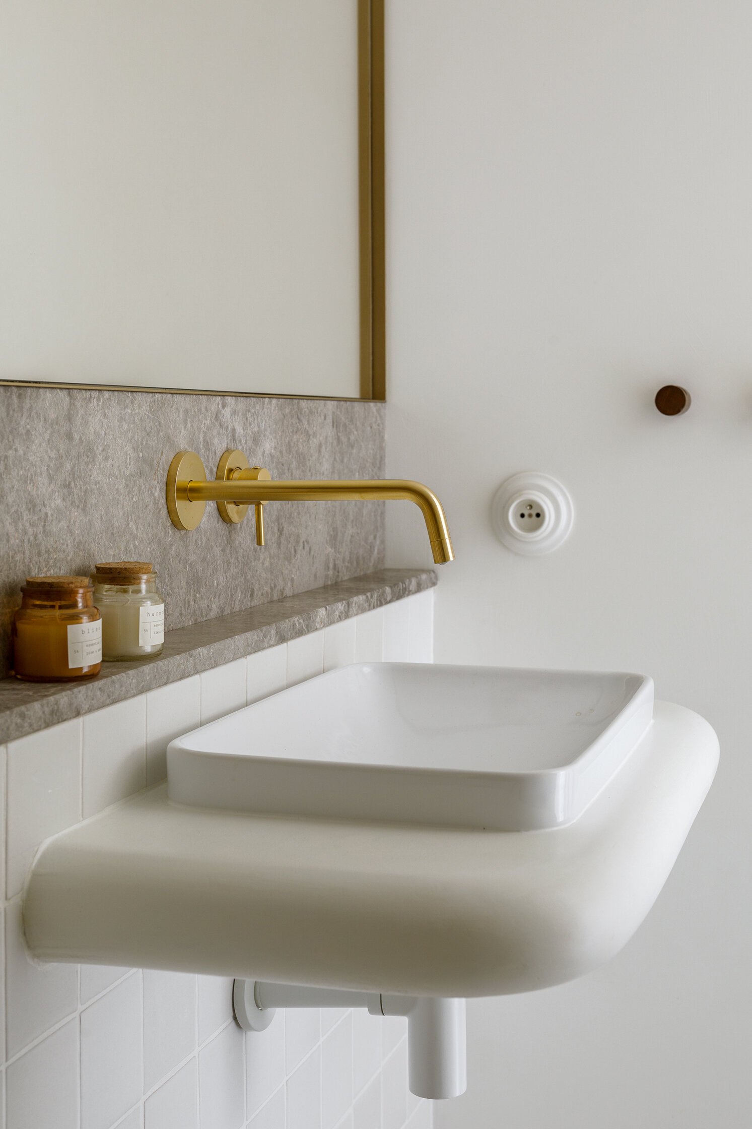 A minimal powder room where soft forms and refined finishes create a seamless extension of the home’s calm aesthetic.
