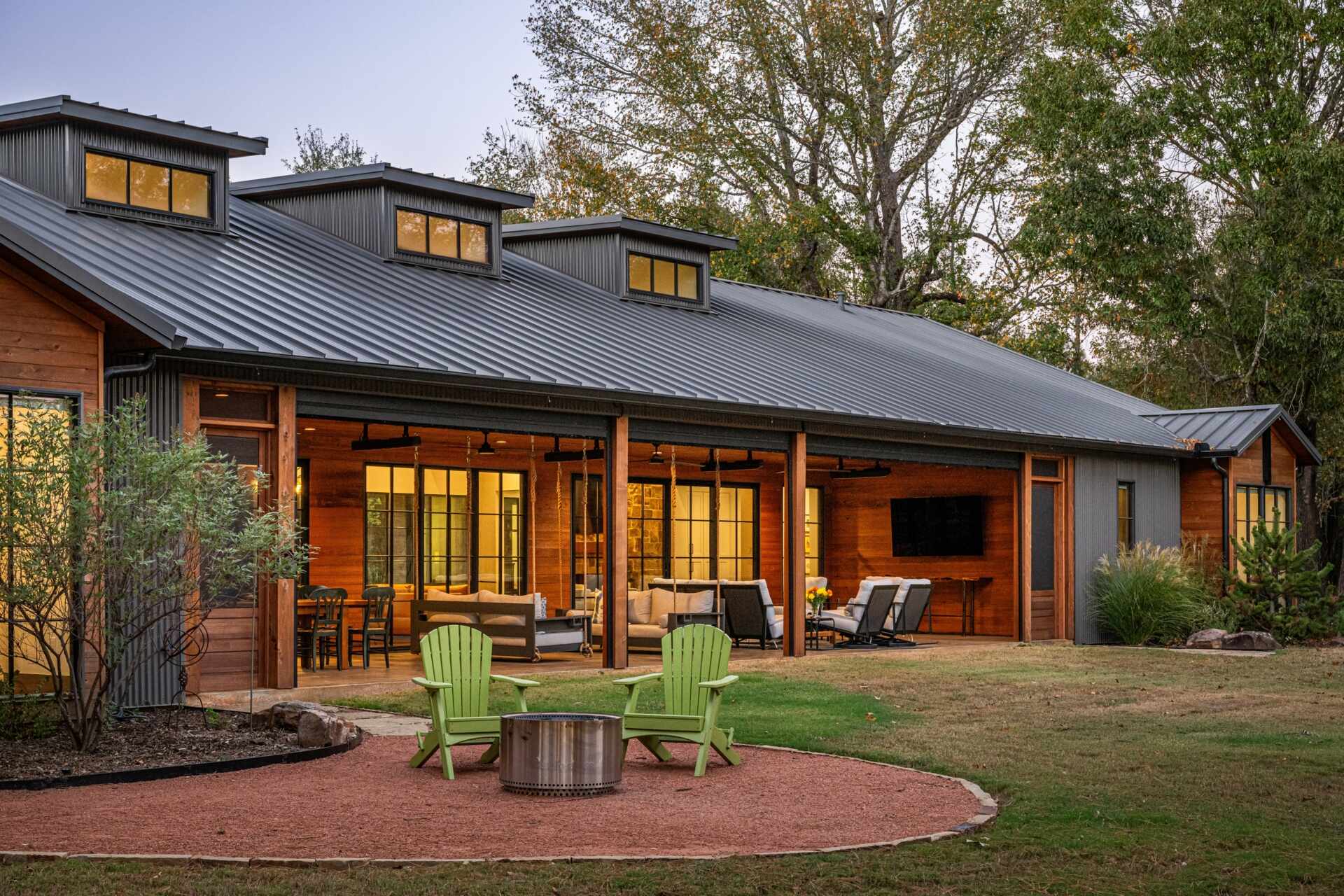 The patio extends the interiors. Fixed screen doors allow access when larger insect screens are deployed. The porch, furnished with a variety of seating area, is carefully proportioned to maximize light, ventilation, and visual connection to the pond and tree canopy, supporting both casual and formal gatherings.