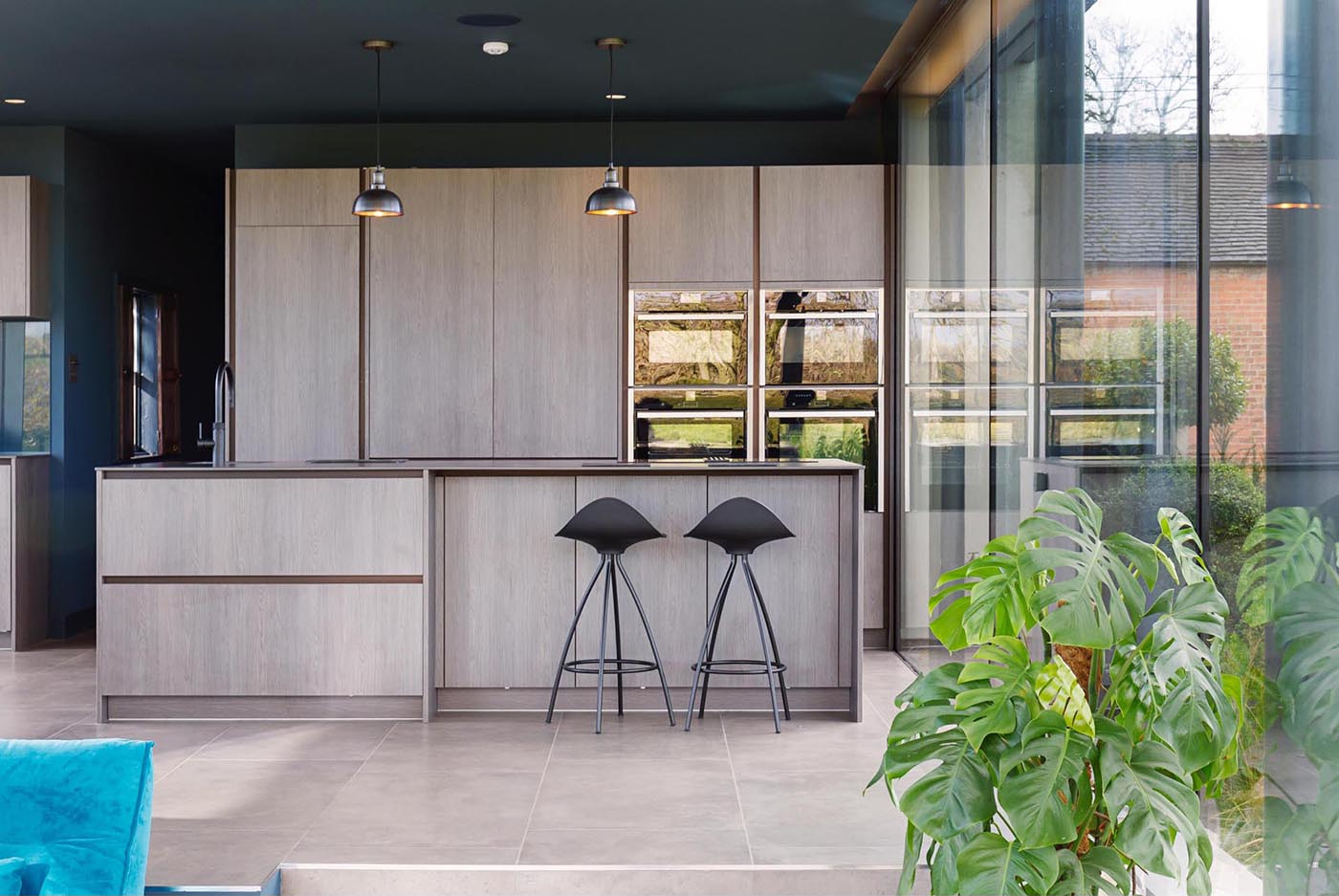 Light wood cabinetry and a dark countertop create a clean, modern kitchen with a warm, balanced feel.