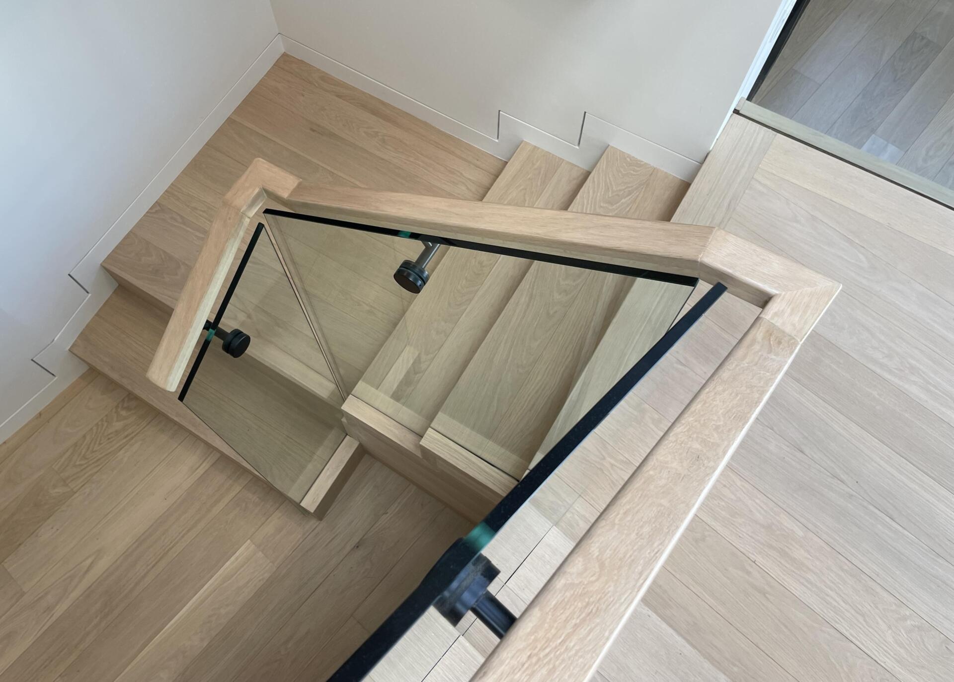 A central wood staircase ties the home together vertically. Running beneath a skylight, it brings light into the core of the house. As you move up or down, the changing light adds to the experience.