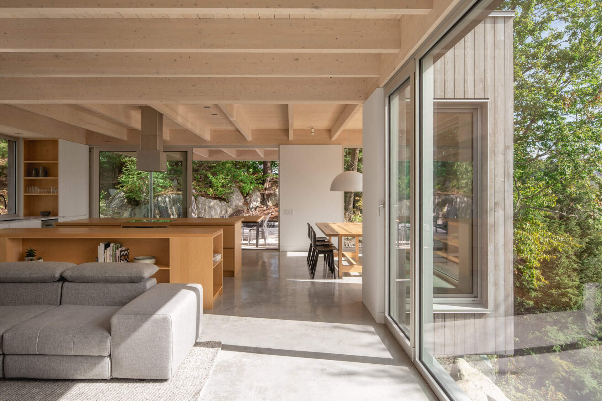 Dos islas de arce macizo y gabinetes de madera contrachapada crean una cocina cálida y natural diseñada para cocinar y reunirse.