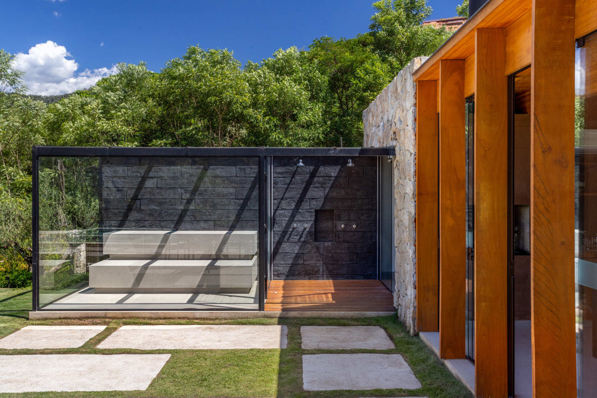 Located at one of the house is a sauna and outdoor showers that feature a black accent wall.