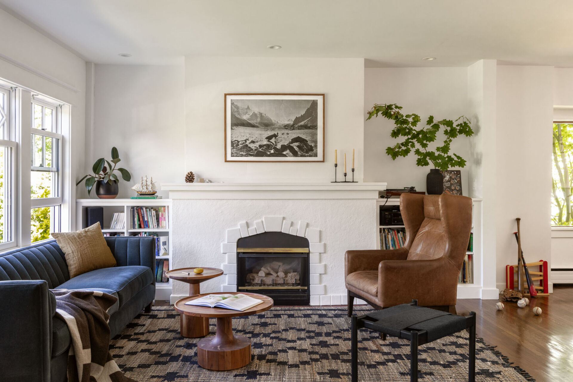 Soft white walls and warm wood tones bring new light and openness to the original interiors of this renovated Craftsman home.