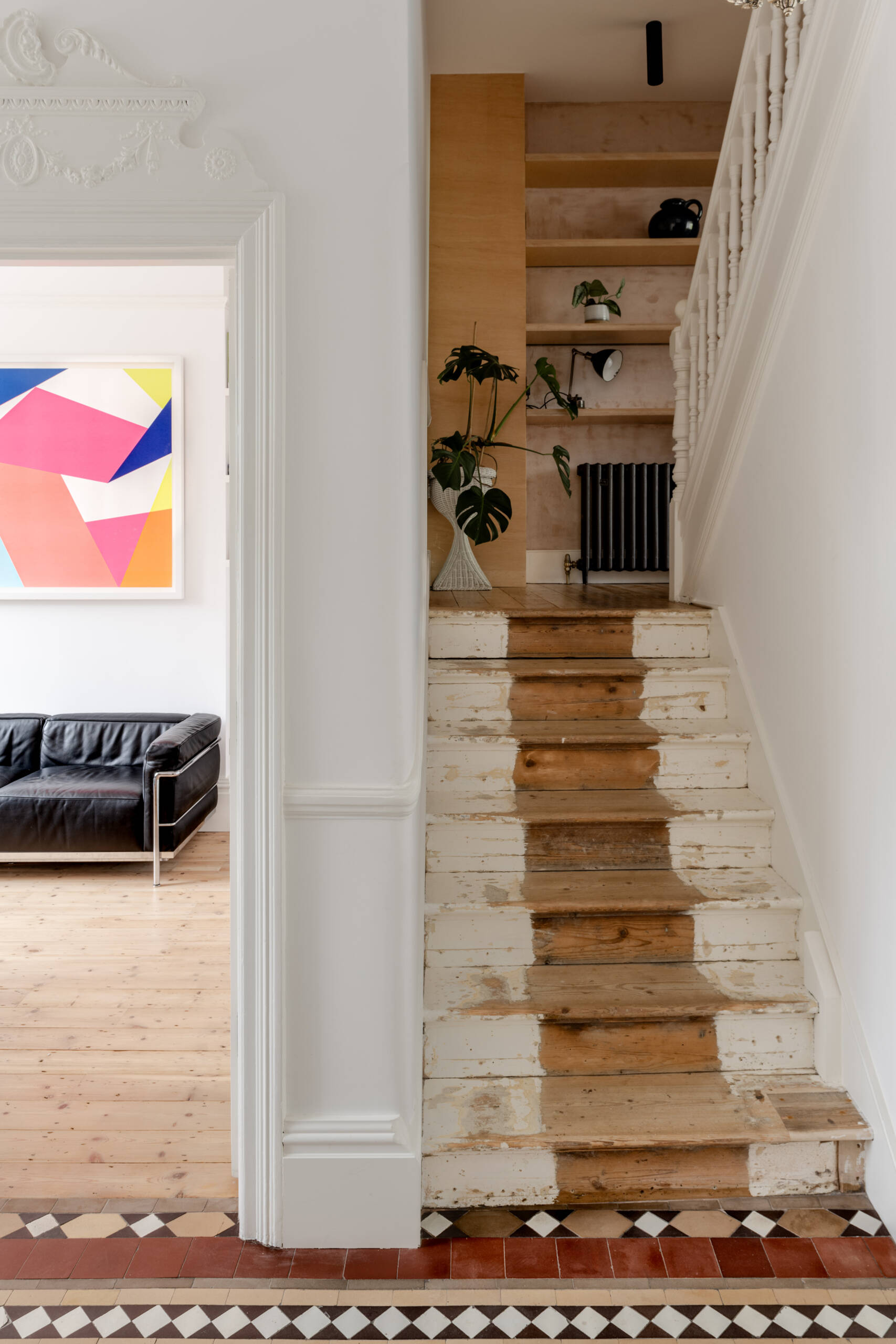 The original stairs remain part of the Edwardian structure, alongside preserved timber beams, cornicing, and tiled floors that maintain the home’s historic character.