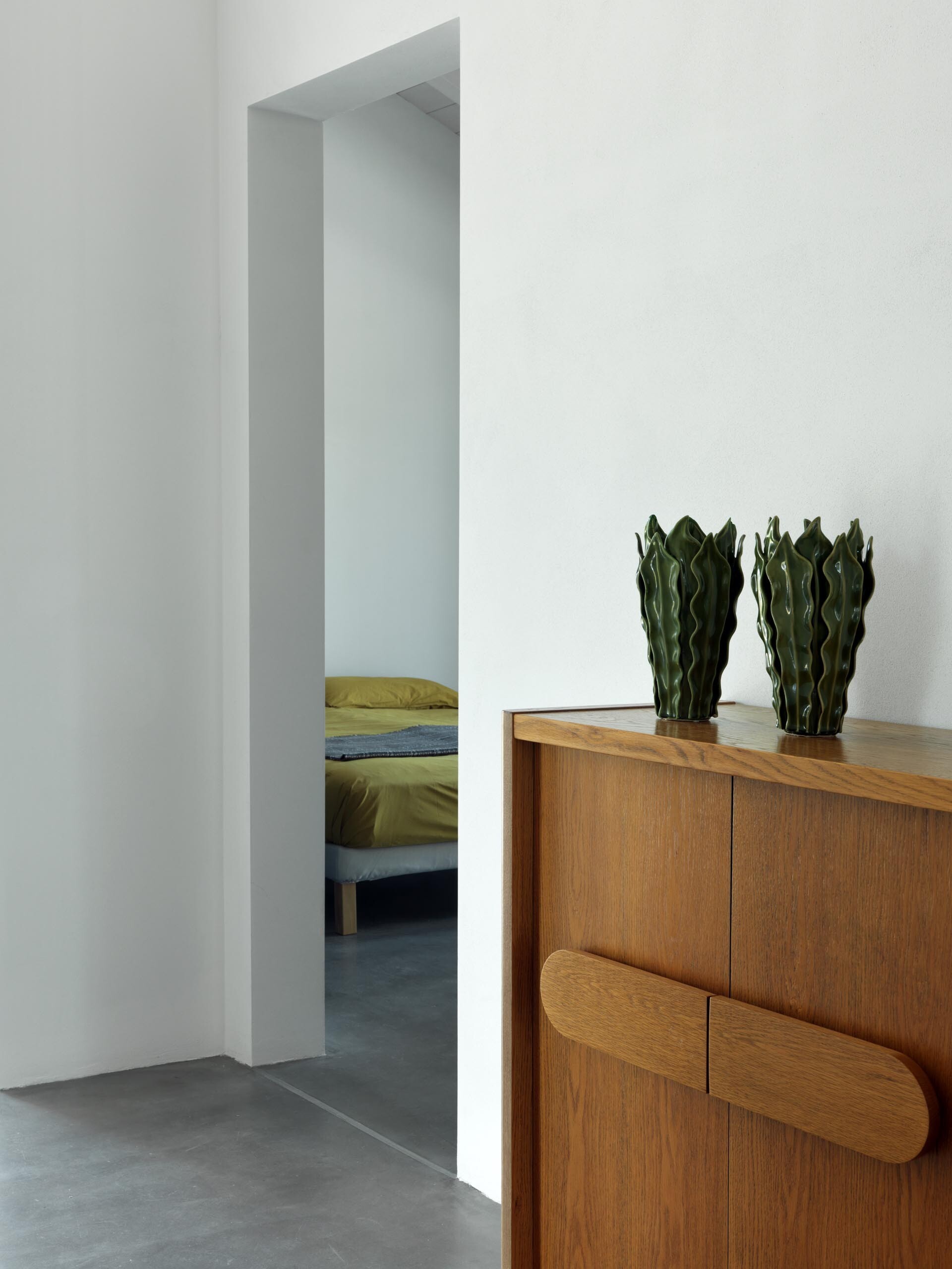 Each bedroom with an ensuite bathroom opens to the garden, offering tranquil views and a minimalist design that highlights nature.