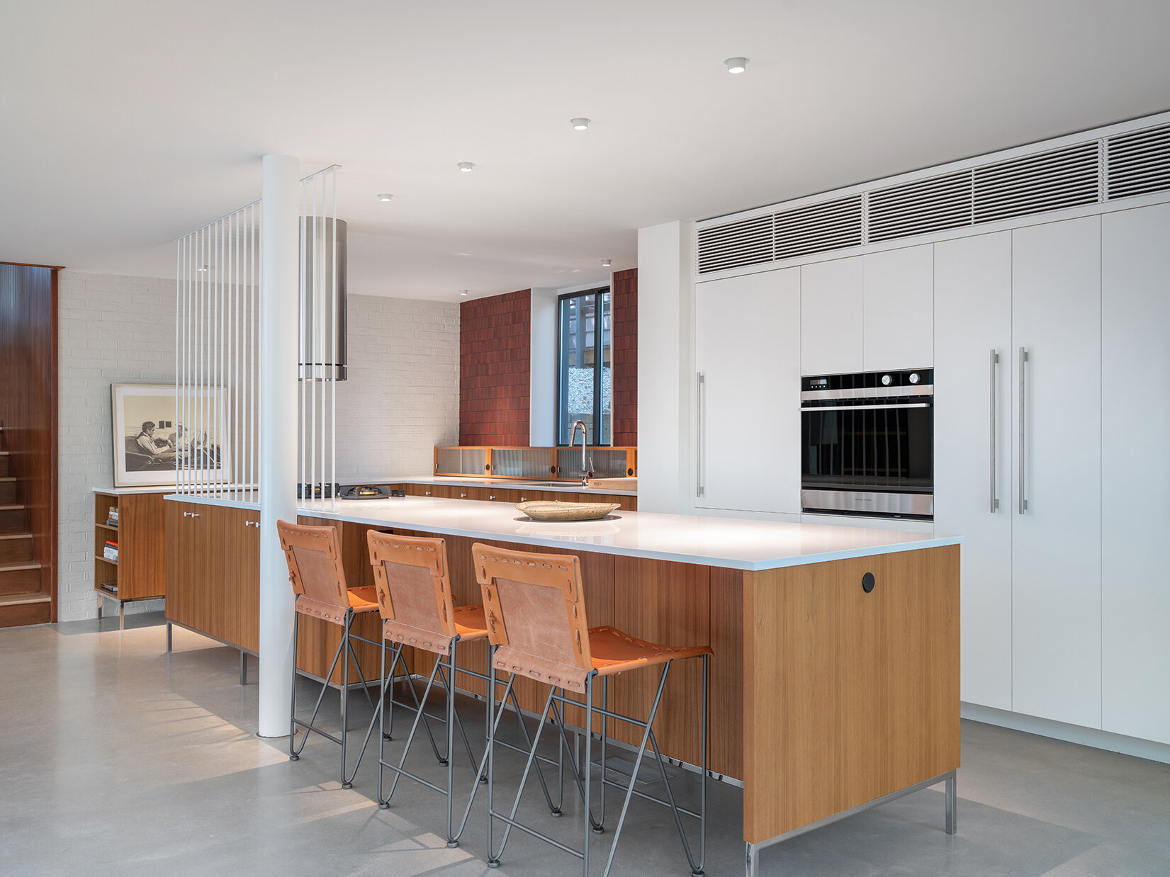 In this mid-century modern inspired kitchen, clean lines and a furniture-like design keep the space open while still providing full functionality.