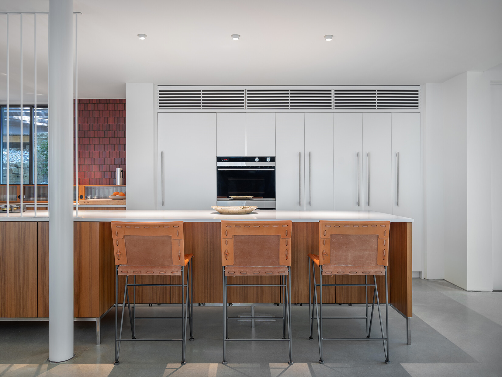 In this mid-century modern inspired kitchen, clean lines and a furniture-like design keep the space open while still providing full functionality.